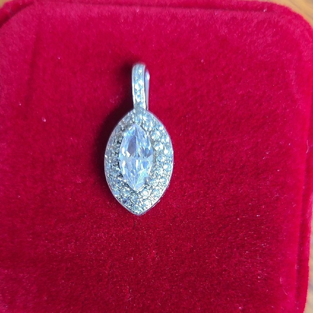 Elegant Silver Pendant with Marquise Center Stone and round stones around it.